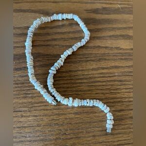 Puka shell necklace.  Brown and white.